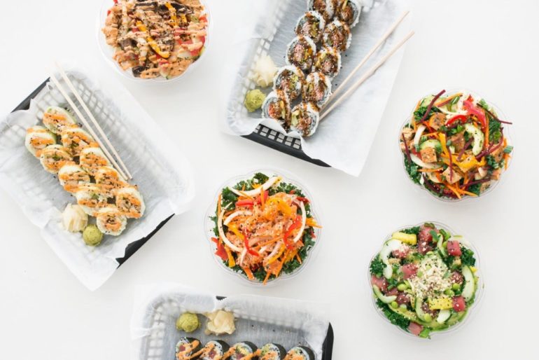 Asian Inspired, Ohio Born, Columbus Bred: ‘FUSIAN’ Is Happening In The Capital City 2 Overhead view of Fusian sushi rolls and fresh salad bowls on a white surface