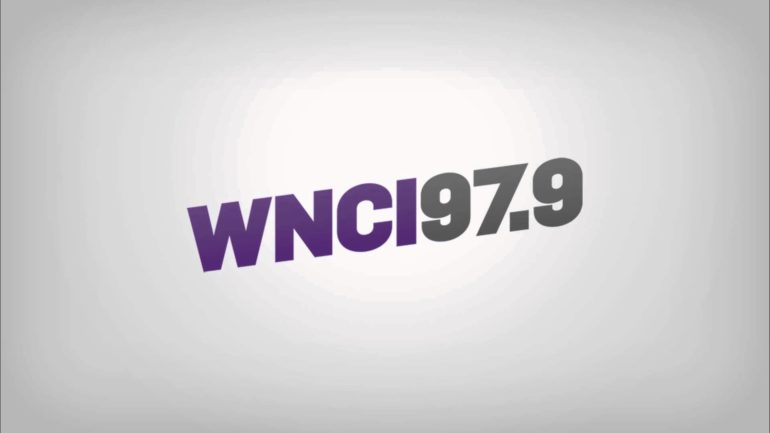 WNCI 97.9 radio station logo on gray background