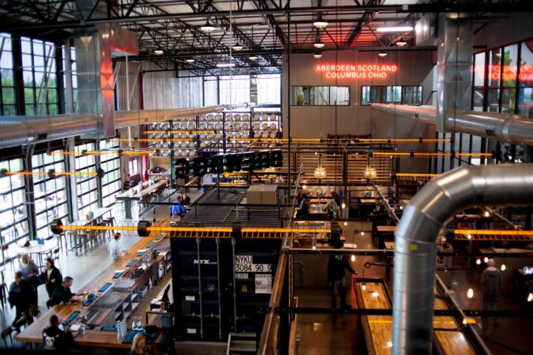 The DogTap at BrewDog's industrial taproom with a neon Aberdeen Scotland Columbus Ohio sign