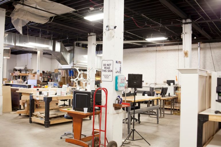 5 Columbus Makerspace Studios For Developing Artisans 3 Interior of a maker space workshop with workbenches, tools, and industrial equipment.