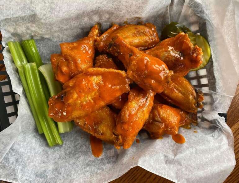 The 10 Best Chicken Wing Joints In Columbus 3 Basket of buffalo wings with celery and a pickle at City Tavern