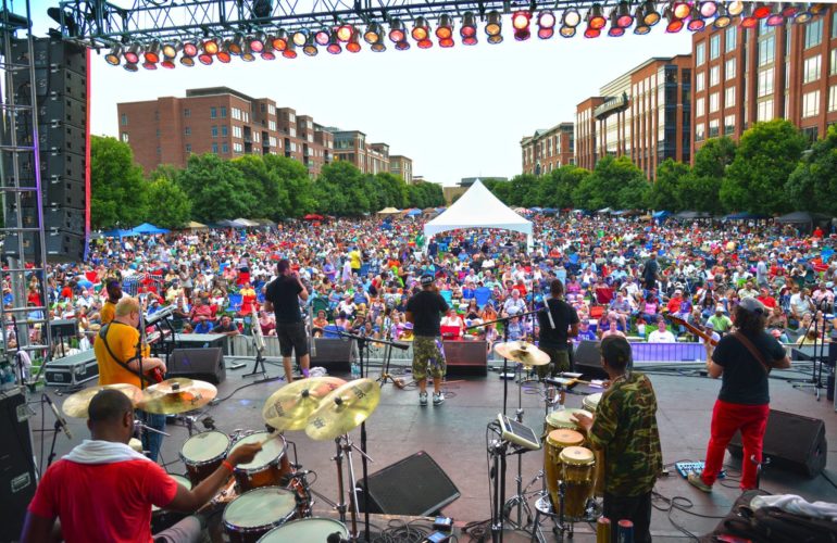 Columbus Jazz & Rib Fest 2026: Dates, Lineup & Guide 4 Large outdoor music festival with band performing on stage before thousands of attendees in urban plaza.
