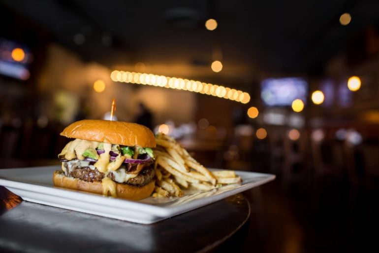 The Best Gastropubs In Columbus For Food, Fun, Fine Dining And Drinks 12 Arch City Tavern burger with red onion and fries on a plate