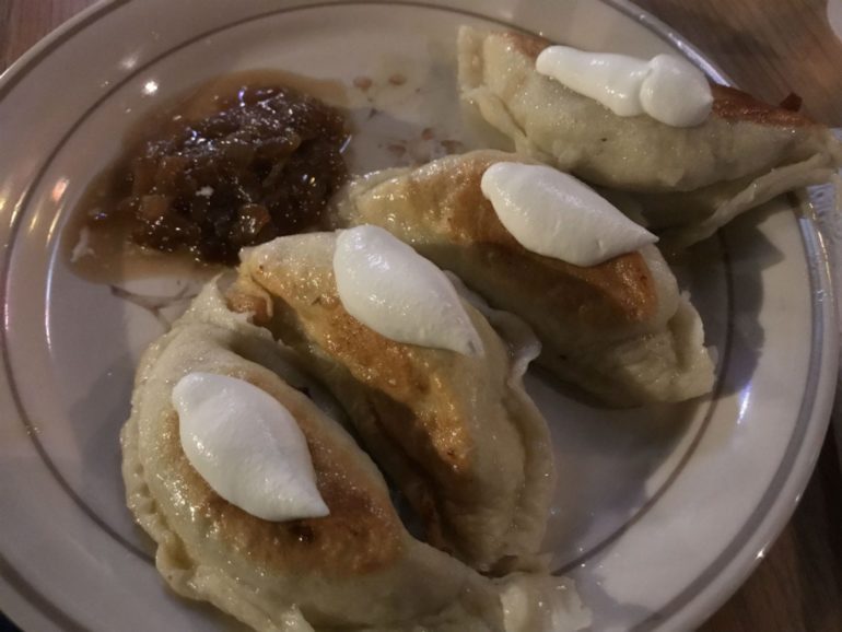 Pierogi Mountain At Bourbon Street Cafe Makes Cheap Delicious Late Night Pierogis 3 Pierogies topped with sour cream served with caramelized onions on plate