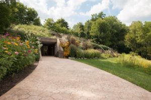 a hotel built into a hillside covered in flowers