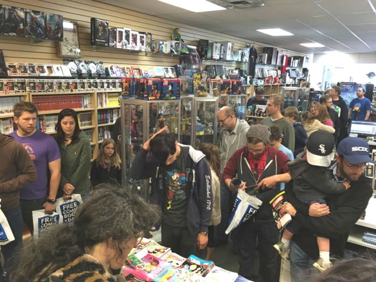 One Of The Best Comic Book Shops In America Is Right Here In Columbus 1 A crowded comic book store with customers browsing shelves and display cases filled with merchandise.