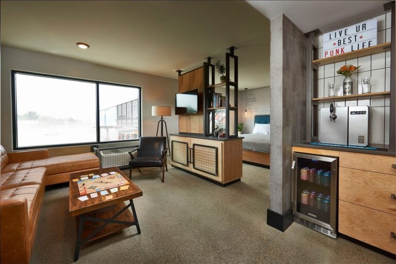 DogHouse Punk Suite with leather seating, wood furnishings, and a beer tap counter