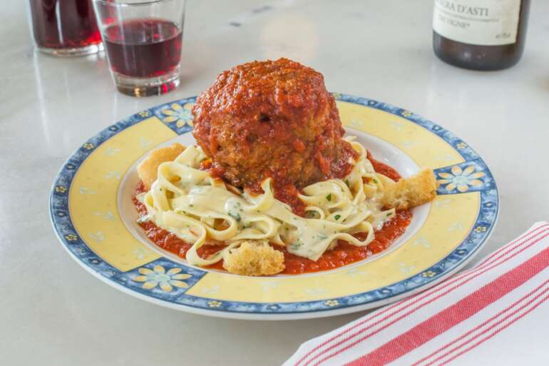 Giant meatball in marinara over fettuccine alfredo at Marcella's