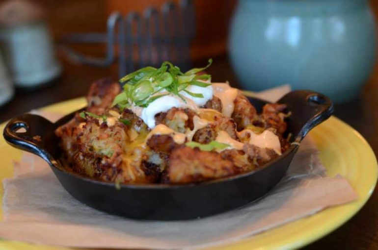 The Best Places To Satisfy Your Tater Tot Cravings In Columbus 2 Skillet of loaded tater tots with cheese, sauce, and scallions at 101 Beer Kitchen