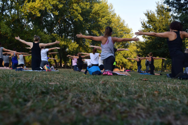 9 Outdoor Fitness Experiences Around Columbus 8 Canva Women Performing Yoga on Green Grass Near Trees