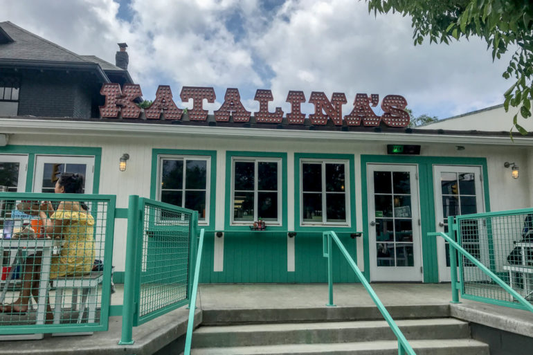 Katalina's Too storefront in Clintonville with teal trim and a marquee sign
