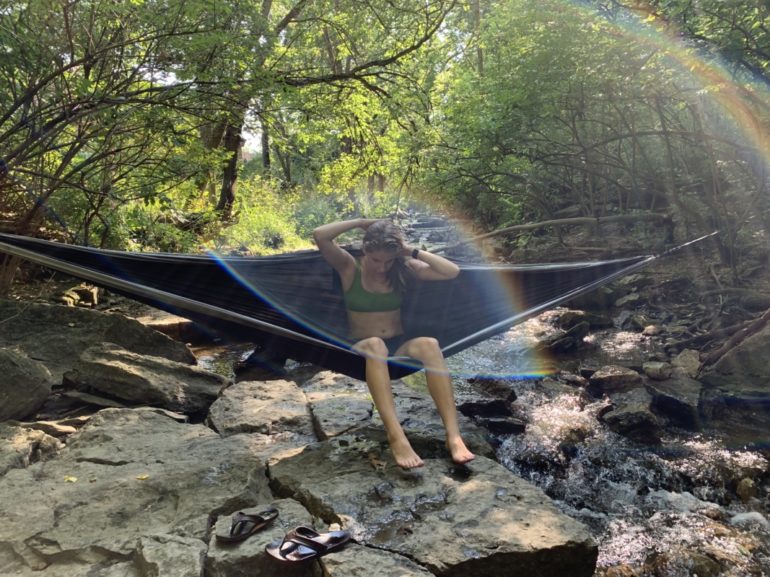 9 Relaxing Places To Chill In Your Hammock Around Columbus 2 Woman relaxing in hammock over rocky stream at Indian Run Falls