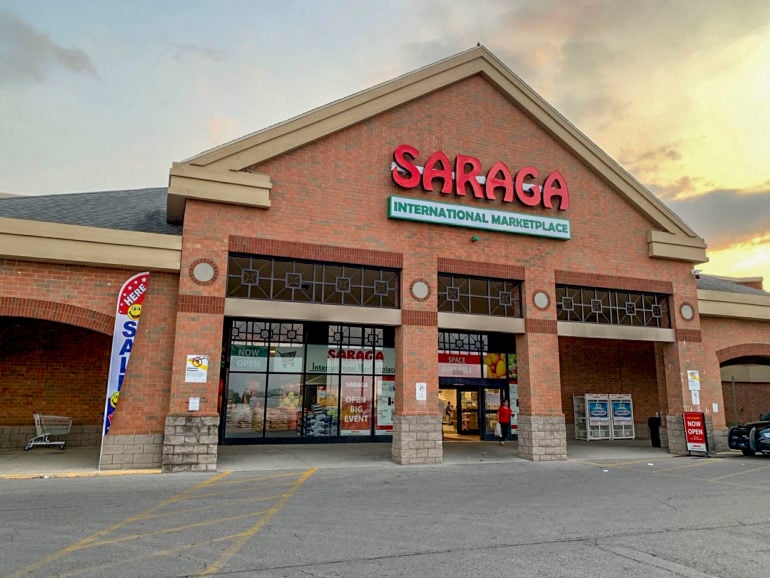 The New Saraga International Grocery Store In North Linden Is A Foodie's Dream 5 Red brick storefront of Saraga International Marketplace with large signage and entrance doors.