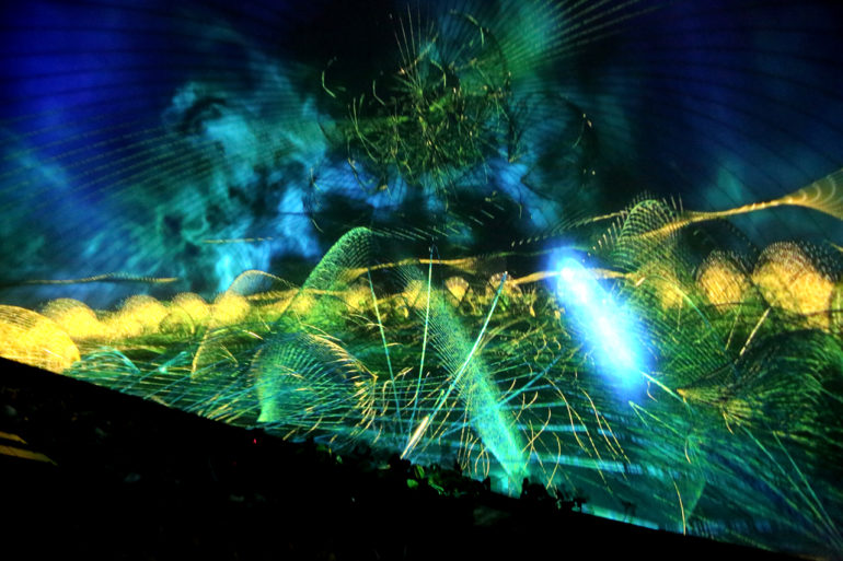 Mesmerica 360 Is The Mind Expanding Experience Everyone Needs Right Now 3 Colorful digital projection of glowing jellyfish with tentacles against dark background.