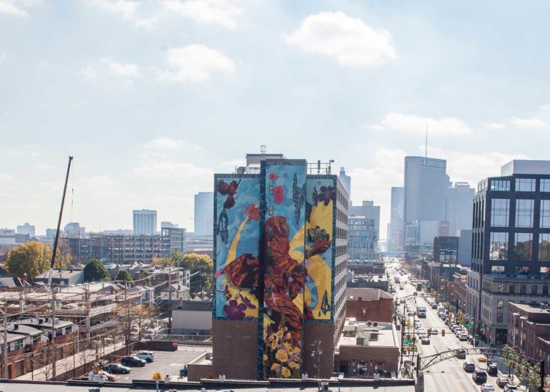 These Augmented Reality Murals In The Short North Are Seriously Breathtaking 3 Large Short North mural of a figure with flowers and birds, city skyline behind