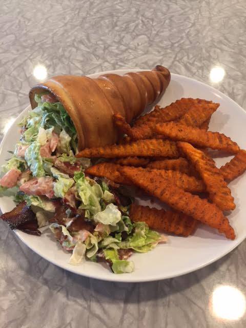 pastry cone filled with lettuce tomatoes and bacon with side of fries