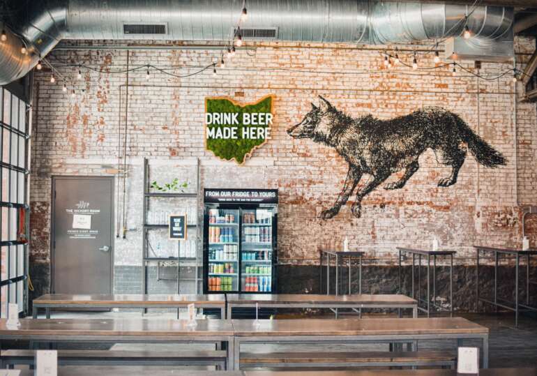 The Best Breweries In Columbus 10 Wolf's Ridge Brewing taproom with wolf mural on brick wall