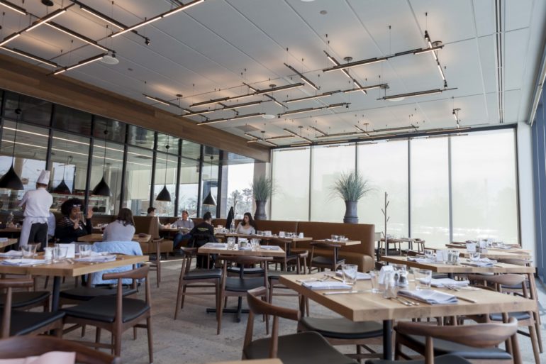 Degrees restaurant dining room with floor-to-ceiling windows and wood furnishings