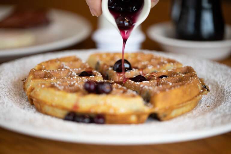 The Best Waffles In Columbus 4 The Original Pancake House waffle with berry sauce and powdered sugar