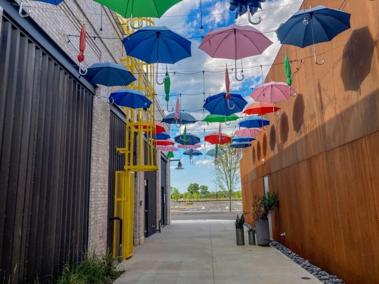 Umbrella Alley installation with colorful umbrellas suspended over a walkway