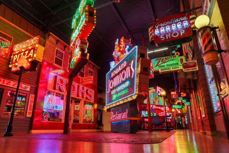 The Weirdest Museums In Ohio 6 Vintage illuminated storefront signs lining an indoor street at American Sign Museum