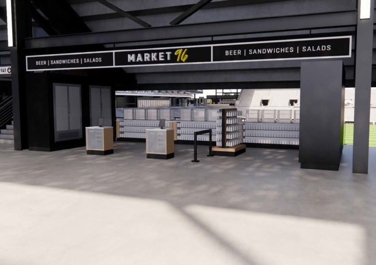 Modern Market 96 restaurant storefront with beer, sandwiches, and salads signage in stadium setting.