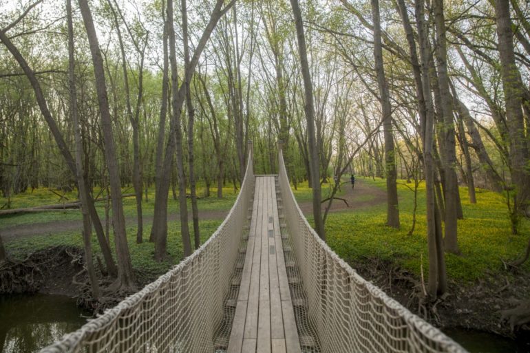 The 10 Best Things To Do At Scioto Grove Metro Park 5 Suspension bridge with rope railings crossing a creek at Scioto Grove Metro Park