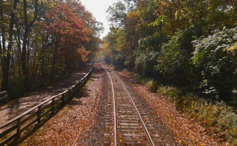 7 Fall Train Rides in Ohio Worth the Drive From Columbus 5 Railroad tracks curve through a forest of colorful fall foliage