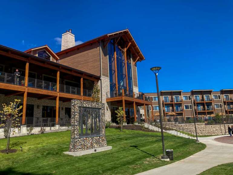 This Stunning Lodge In Hocking Hills State Park Is The Ultimate Ohio Vacation Destination 6 Modern residential complex with stone and wood architecture under clear blue sky