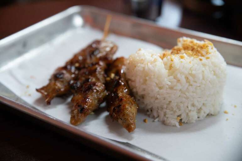 This Incredible Filipino Restaurant Is Hidden Away In A Strip Mall Near Westerville 15 Grilled meat skewers served with white rice on a white plate.