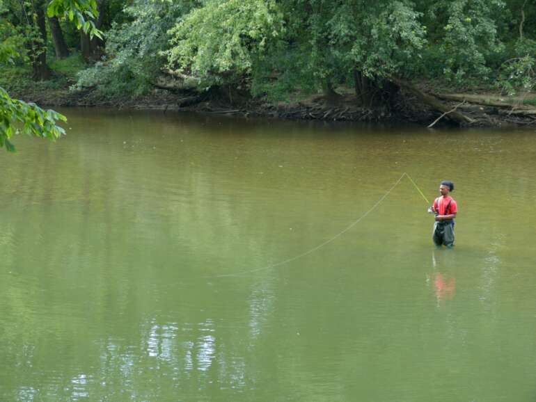 The Best Things To Do At Three Creeks Metro Park 11 Man fly fishes while wading in the river at Three Creeks Metro Park