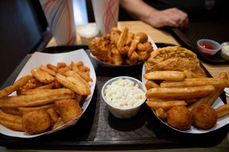 Marino's Seafood Is The Dose Of Columbus Nostalgia You've Been Craving 2 Marino's Fish & Chips tray with fried fish, fries, hushpuppies, and coleslaw