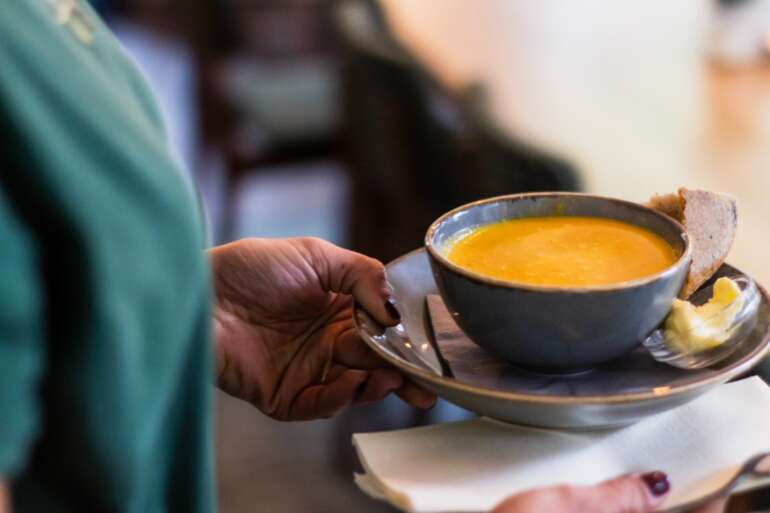 12 Places To Get A Great Bowl Of Soup In Columbus 2 person carrying bowl of soup