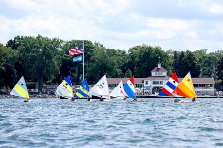 The 9 Most Charming Beach Towns In Ohio 2 Small sailboats racing on the water in front of Lakeside Chautauqua