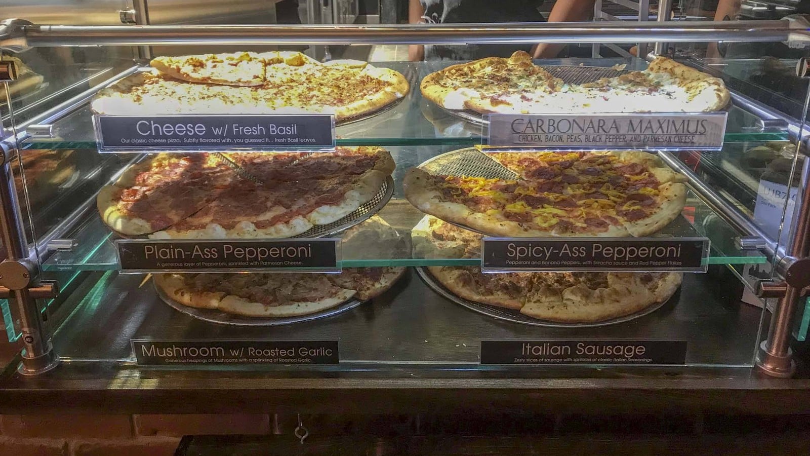 Pizza slices in the display case at Mikey's Late Night Slice