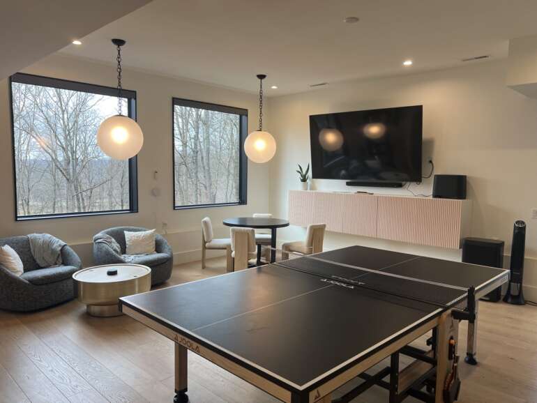 This Scandinavian Inspired Cabin In Hocking Hills Is A Cozy, Elegant Getaway 4 hangout space in cabin with ping pong table