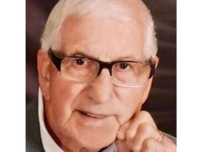 The Former Owner Of Beloved South End Pizzeria Has Passed Away 7 Older man with white hair and glasses in professional headshot portrait.