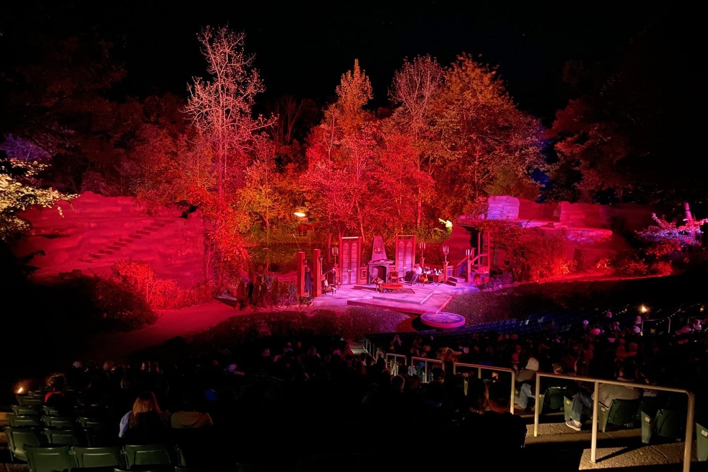 Sugarloaf Mountain Amphitheatre lit red at night for Haunted Mountain in Chillicothe, with the Dracula stage set and the audience in the seats