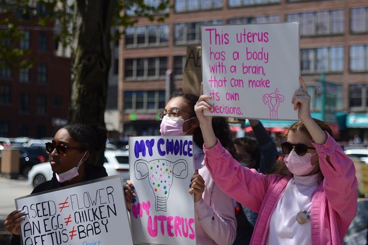 people holding signs at pro-choice rally