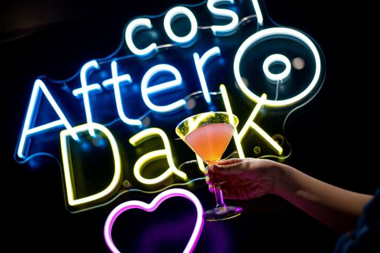 cocktail in front of neon sign