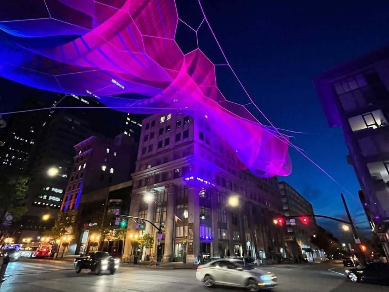suspended sculpture lit up at night