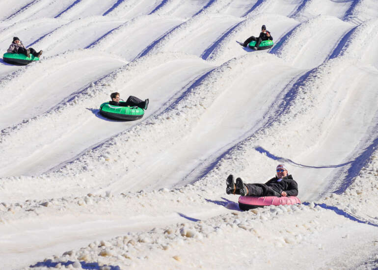 Ohio’s Largest Tubing Park Is the Winter Adventure You Need Right Now 7 people tubing at mad river mountain