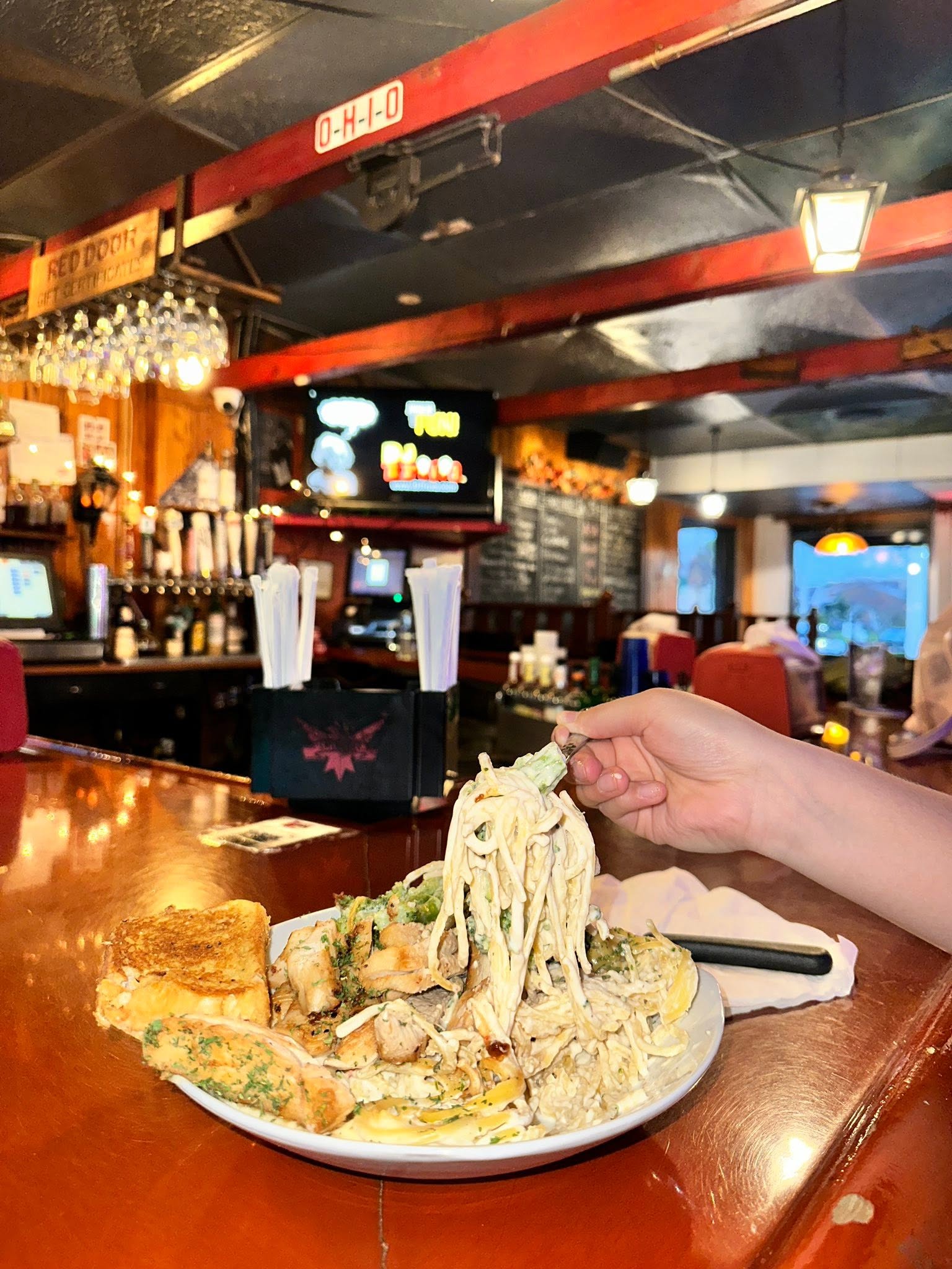 plate full of pasta sitting on bar counter