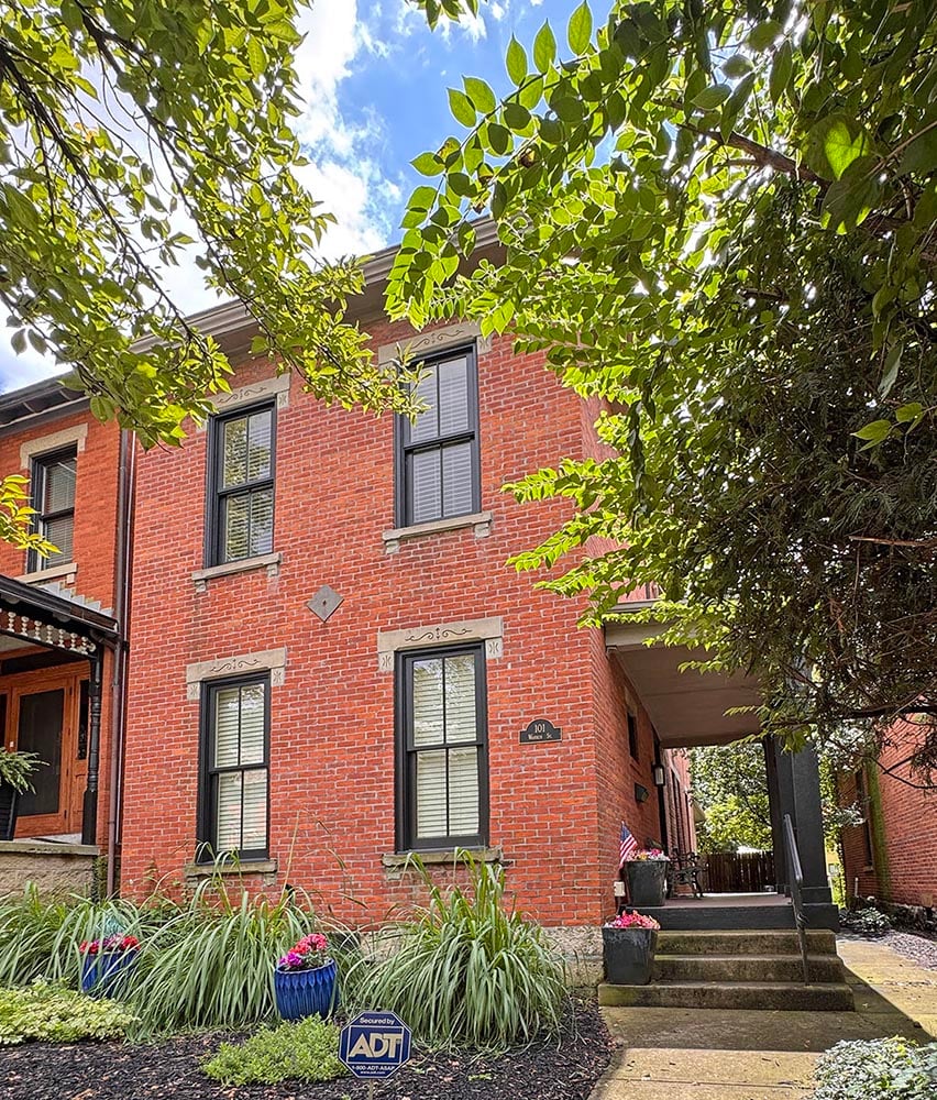 historic brick home with trees