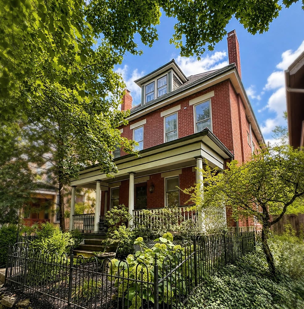 brick house surrounded by trees