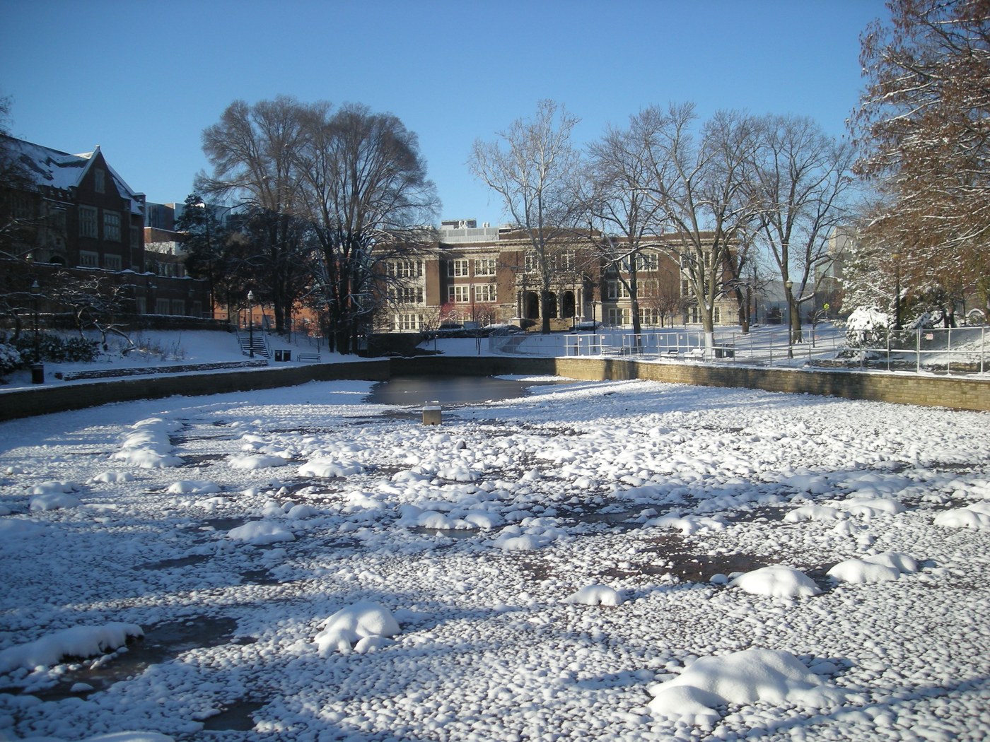 Mirror Lake in winter on the Ohio State University campus in Columbus, with Pomerene Hall behind it