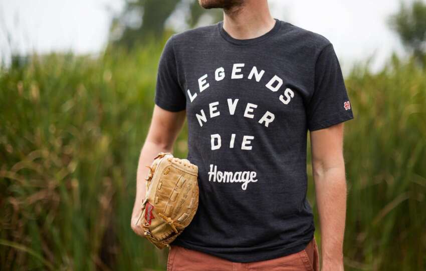 man wearing homage t-shirt in field