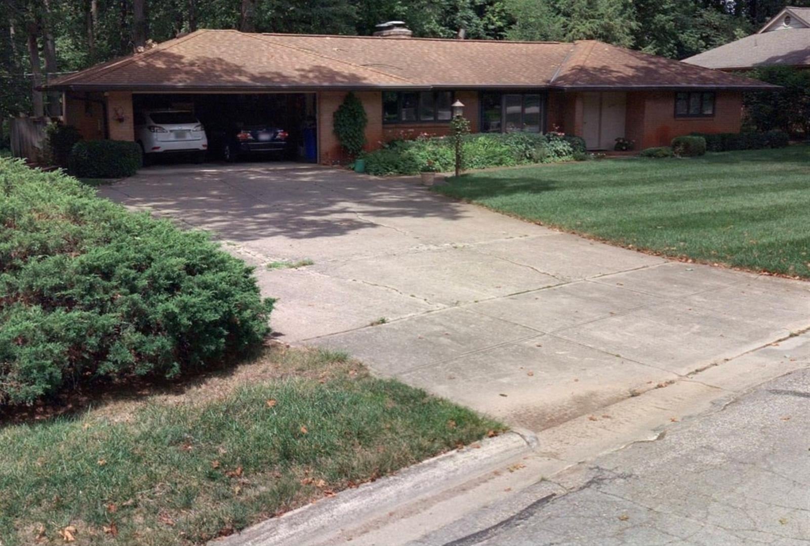 brick ranch house with an open garage and concrete driveway upper arlington ohio