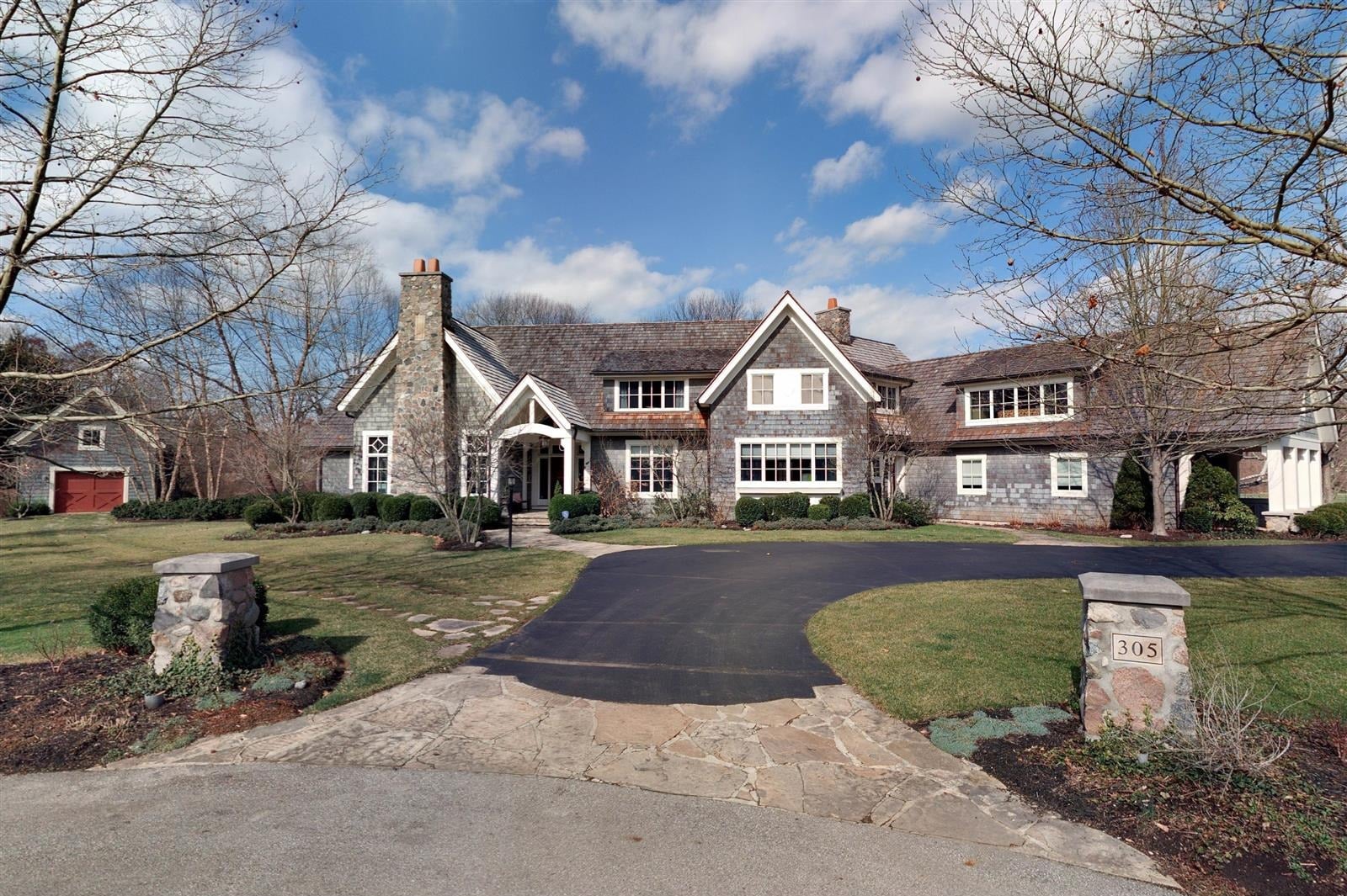 shingle style house with a stone chimney and circular driveway bexley ohio