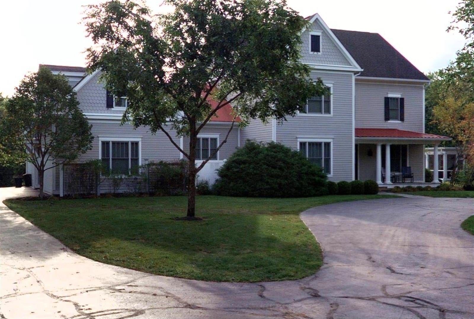 gray clapboard house with a red metal porch roof new albany ohio